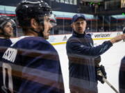 Seattle Kraken head coach Dave Hakstol discusses a drill with players during training camp at Kraken Community Iceplex last month in Seattle.