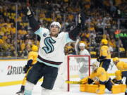 Seattle Kraken left wing Brandon Tanev celebrates after scoring a goal against the Nashville Predators in the first period of an NHL hockey game Thursday, Oct. 14, 2021, in Nashville, Tenn.