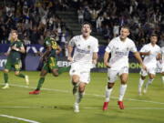 LA Galaxy midfielder Sacha Kljestan, center, celebrates after scoring on a penalty kick during the second half against the Portland Timbers in an MLS soccer match Saturday, Oct. 16, 2021, in Carson, Calif.