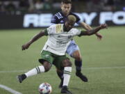 Portland Timbers forward Dairon Asprilla, right, controls the ball against Vancouver Whitecaps defender Marcus Godinho, left, during the first half of an MLS soccer match in Portland, Ore., Wednesday, Oct. 20, 2021.