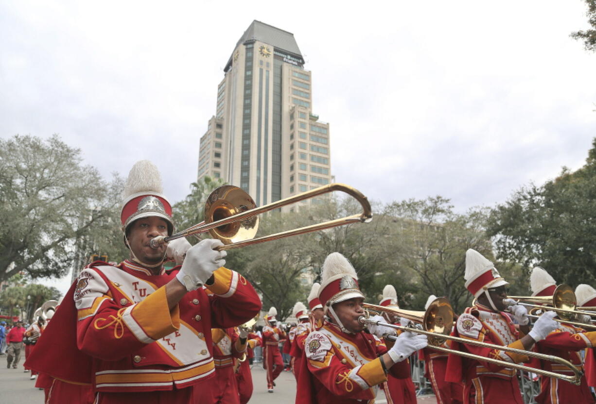 FILE - Members of the Tuskegee University Marching Crimson Piper band perform during the Martin Luther King Jr., Day parade in St. Petersburg, Fla., Monday, Jan. 16, 2017. Members of the Tuskegee University marching band are threatening to quit performing at school events to protest what they say is a lack of resources and support. WSFA-TV reports that concerned members of the Marching Crimson Pipers released a statement Saturday through the Tuskegee Student Government Association complaining about conditions within the program.