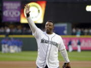 FILE  - Former Seattle Mariners outfielder Ken Griffey Jr. waves to fans after being introduced before a baseball game against the Texas Rangers in Seattle, in this Friday, April 14, 2017, file photo. Hall of Famer Ken Griffey Jr. is investing in the Seattle Mariners in a way he never has before. He'll be part of the ownership going forward. The Mariners announced Monday, Oct. 25, 2021, that their most famous former player has also become the first one to purchase a stake in the ball club.