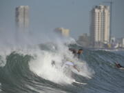 People surf at Pinitos beach prior landfall of tropical storm Pamela, in Mazatlan, Mexico, Tuesday, Oct. 12, 2021. Hurricane Pamela weakened to a tropical storm Tuesday afternoon as it meandered off Mexico's Pacific coast. Forecasters said it was expected to regain strength overnight and be a hurricane when making landfall somewhere near the port of Mazatlan Wednesday.