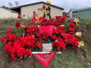 A memorial for the suspect killed by Clark County Sheriff's deputies early Sunday morning sprung up by Sunday afternoon on 49th Street in east Vancouver.