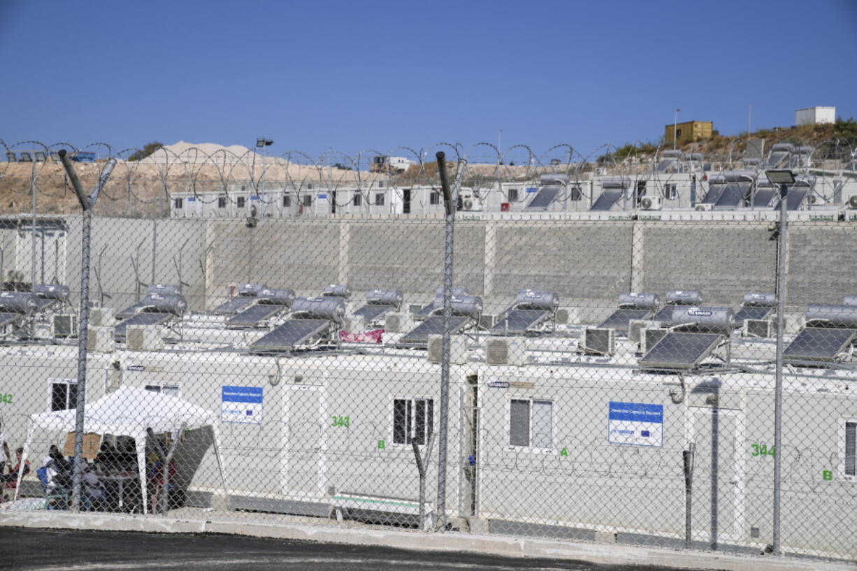 A partial view of the new closed monitored facility for migrants and refugees in Zervou village, on the eastern Aegean island of Samos, Greece, Friday, Oct. 1, 2021. Greek authorities have moved ten days ago asylum-seekers living in a squalid camp on the island of Samos into a new facility on the island, where access are more strictly controlled.