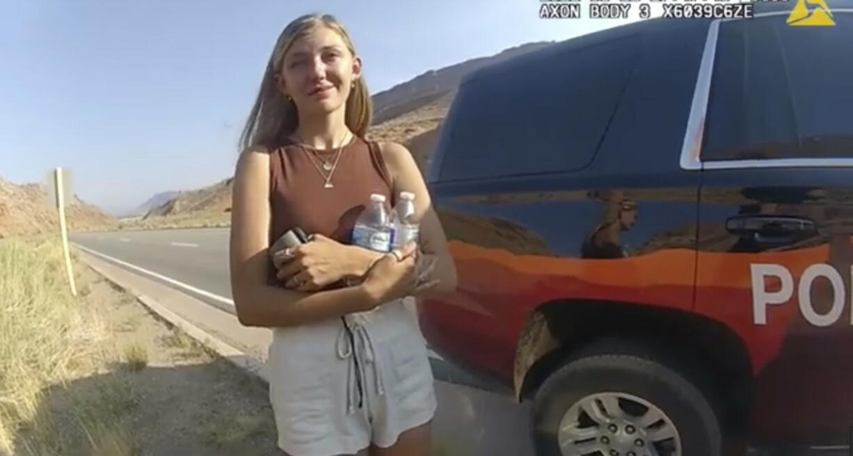 FILE - This Aug. 12, 2021 file photo from video provided by The Moab Police Department shows Brian Laundrie talking to a police officer after police pulled over the van he was traveling in with his girlfriend, Gabrielle "Gabby" Petito, near the entrance to Arches National Park. Laundrie, the boyfriend of Gabby Petito, whose body was found at a national park in Wyoming after a cross-country trip with him, has been charged with unauthorized use of a debit card as searchers continue looking for him in Florida swampland, federal authorities announced Thursday, Sept. 23, 2021.