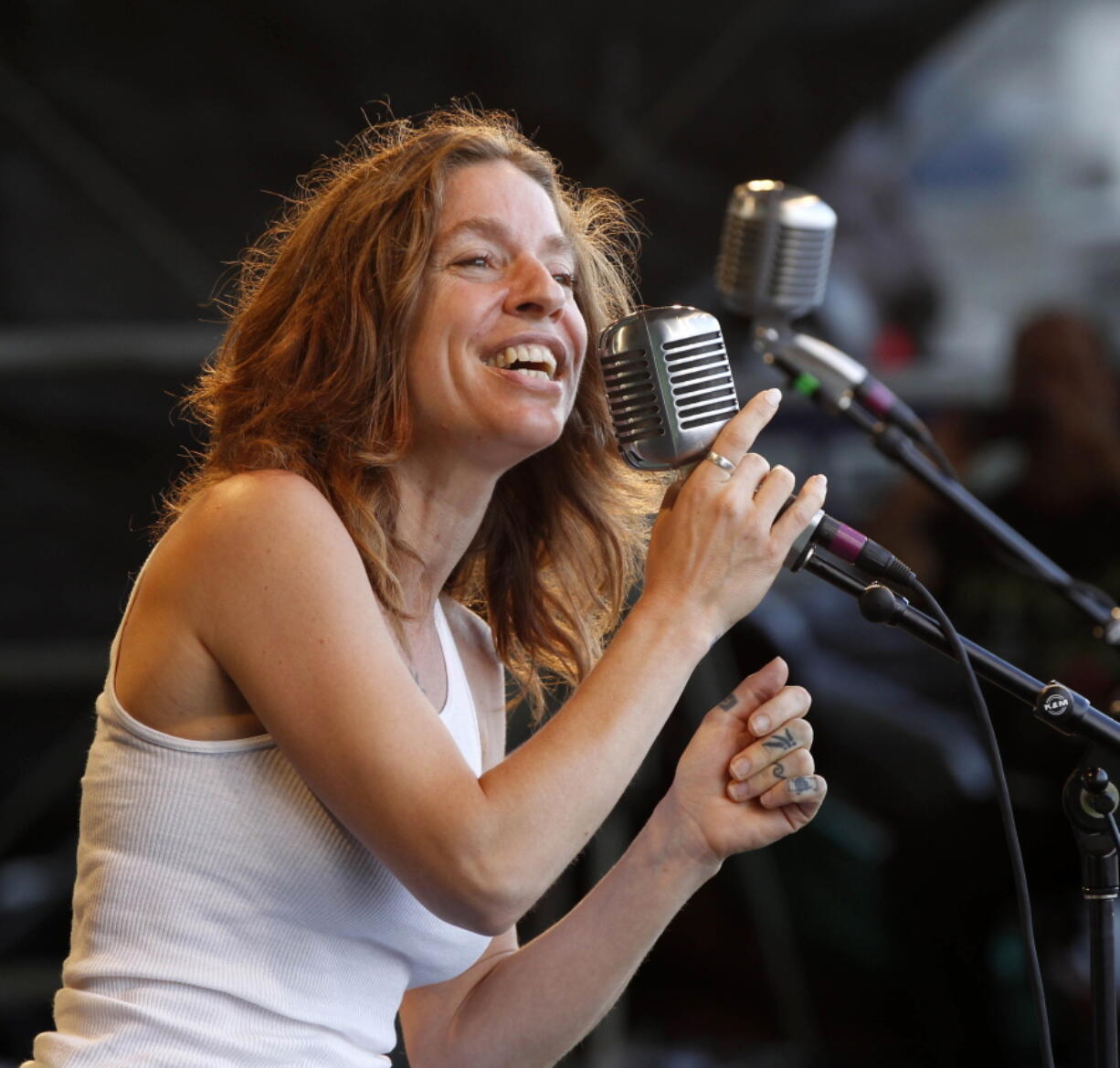 FILE - In this May 6, 2012 file photo, Ani DiFranco performs with the Preservation Hall Jazz Band at the New Orleans Jazz and Heritage Festival in New Orleans.  DiFranco is the honoree and will perform at the 41st annual John Lennon tribute concert in December in New York.  DiFranco shares a drive toward social activism with the late Beatle, a point noted in a statement from his widow Yoko Ono.