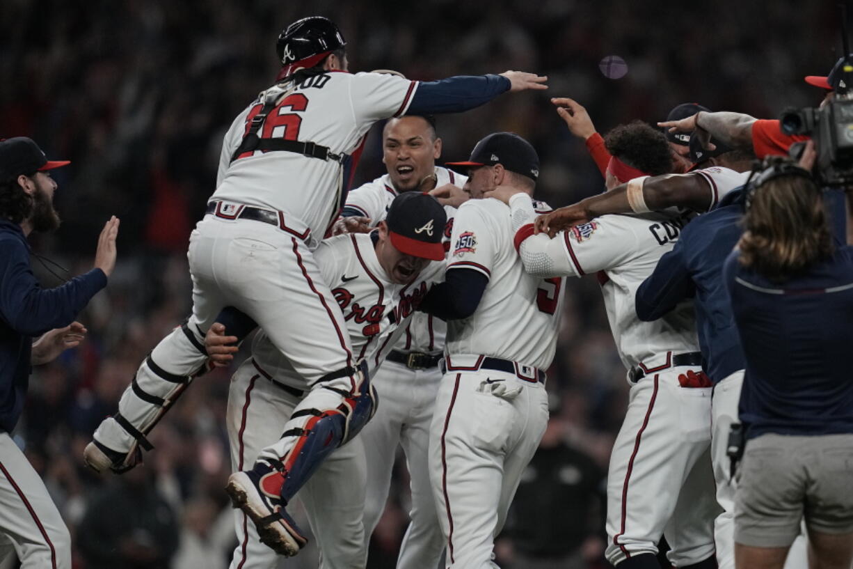 Atlanta Braves celebrate after winning Game 6 of baseball's National League Championship Series against the Los Angeles Dodgers Sunday, Oct. 24, 2021, in Atlanta. The Braves defeated the Dodgers 4-2 to win the series.