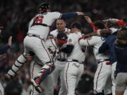 Atlanta Braves celebrate after winning Game 6 of baseball's National League Championship Series against the Los Angeles Dodgers Sunday, Oct. 24, 2021, in Atlanta. The Braves defeated the Dodgers 4-2 to win the series.