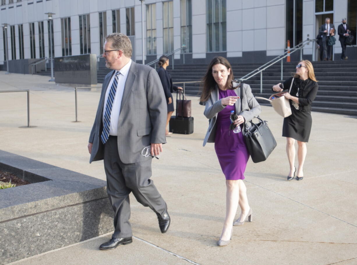 Attorneys and staff associated with a federal trial of pharmacies, CVS, Walgreens, Giant Eagle and Walmart, leave the Carl B. Stokes Federal Courthouse in Cleveland, Monday, Oct. 4, 2021. The pharmacies are being sued by Ohio counties Lake and Trumbull for their part in the opioid crisis.