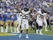 Oregon running back Travis Dye (26) celebrates his rushing touchdown during the first half of an NCAA college football game against UCLA, Saturday, Oct. 23, 2021, in Pasadena, Calif.