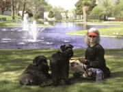 Penny Wagner appears with her two dogs, Clarence, left, and Cooper in Albuquerque, N.M., on April 8, 2020.