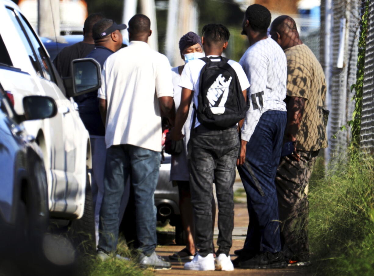 Family members of victims and employees pray outside of a post office after a shooting, Tuesday, Oct. 12, 2021 in the Orange Mound neighborhood of Memphis, Tenn.