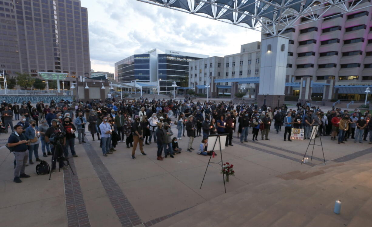 FILE - A large crowd of movie industry workers and New Mexico residents attend a candlelight vigil to honor cinematographer Halyna Hutchins in downtown Albuquerque, N.M. Saturday, Oct. 23, 2021. Hutchins was killed when Alec Baldwin fired a weapon on a film set that a crew member told him was safe. The tragedy has led to calls for fundamental change in Hollywood: the banning of real guns on sets.