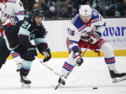 Seattle Kraken center Alex Wennberg (21) and New York Rangers center Ryan Strome (16) battle for the puck during the first period of an NHL hockey game, Sunday, Oct. 31, 2021, in Seattle.