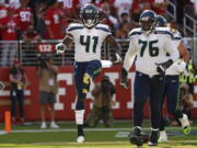 Seattle Seahawks running back Alex Collins (41) celebrates after scoring a touchdown against San Francisco Sunday.