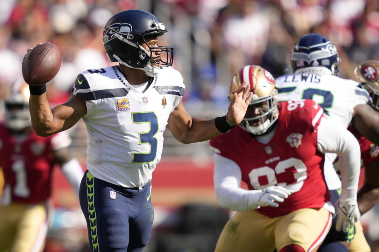 Seattle Seahawks quarterback Russell Wilson (3) passes in front of San Francisco 49ers defensive tackle D.J. Jones during the second half of an NFL football game in Santa Clara, Calif., Sunday, Oct. 3, 2021.