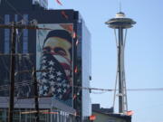 A painting by Shepard Fairey, based on a photo taken by Ted Soqui during a Black Lives Matter protest, is projected onto a building near the Space Needle in Seattle in September. November's election for Seattle city attorney pits a Republican versus an extreme liberal candidate who wants to cease most prosecutions of misdemeanor cases, saying the existing system is racist.