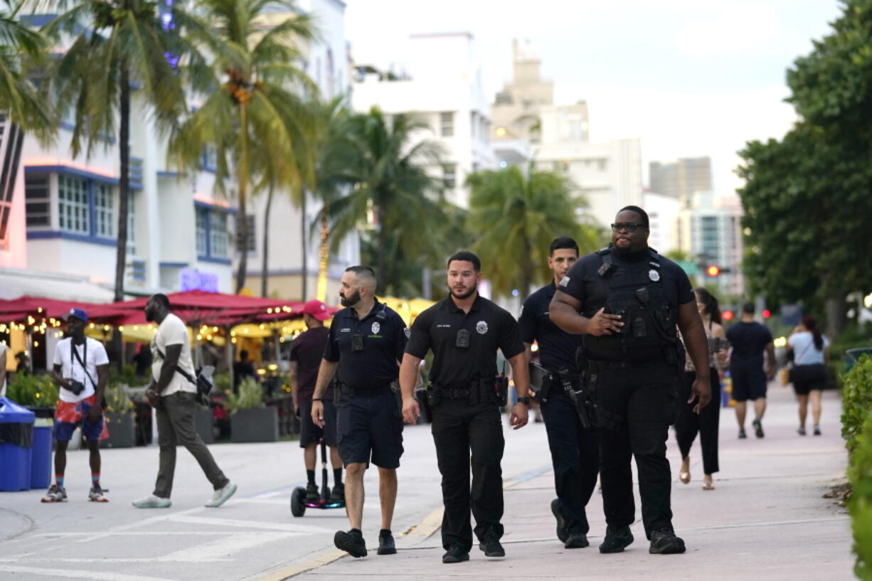 City of Miami Beach code enforcement and police officers patrol along Ocean Drive, Friday, Sept. 24, 2021, in Miami Beach, Fla. For decades, this 10-block area has been one of the most glamorized spots in the world, made cool by TV shows like Miami Vice, where the sexiest models gathered at Gianni Versace's ocean front estate and rappers wrote lines about South Beach's iconic Ocean Drive.