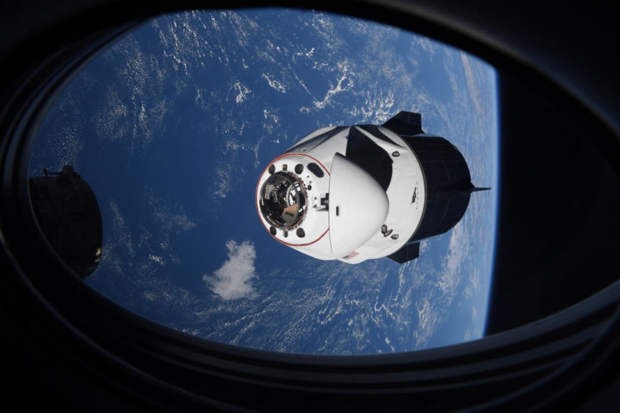 FILE - In this Saturday, April 24, 2021, file photo made available by NASA, the SpaceX Crew Dragon capsule approaches the International Space Station for docking. SpaceX is scrambling to resolve toilet spills in its capsules before it launches another crew for NASA. Liftoff is currently set for early Sunday, Oct. 31, from Florida's Kennedy Space Center.