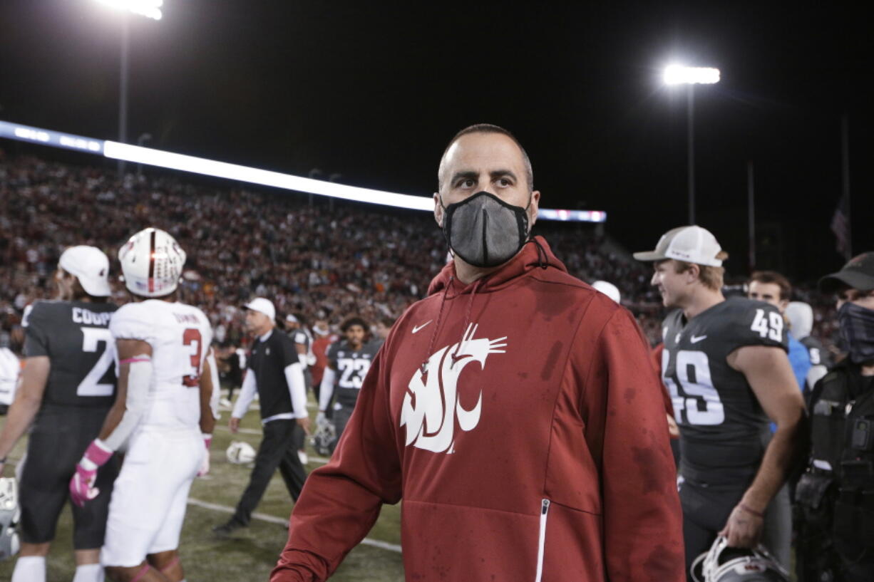 Washington State coach Nick Rolovich walks on the field after the team's NCAA college football game against Stanford, Saturday, Oct. 16, 2021, in Pullman, Wash. Washington State won 34-31.