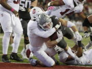 Washington State running back Max Borghi, center right, runs for a touchdown as Stanford linebacker Andres Fox defends during the second half of an NCAA college football game Saturday, Oct. 16, 2021, in Pullman, Wash. Washington State won 34-31.