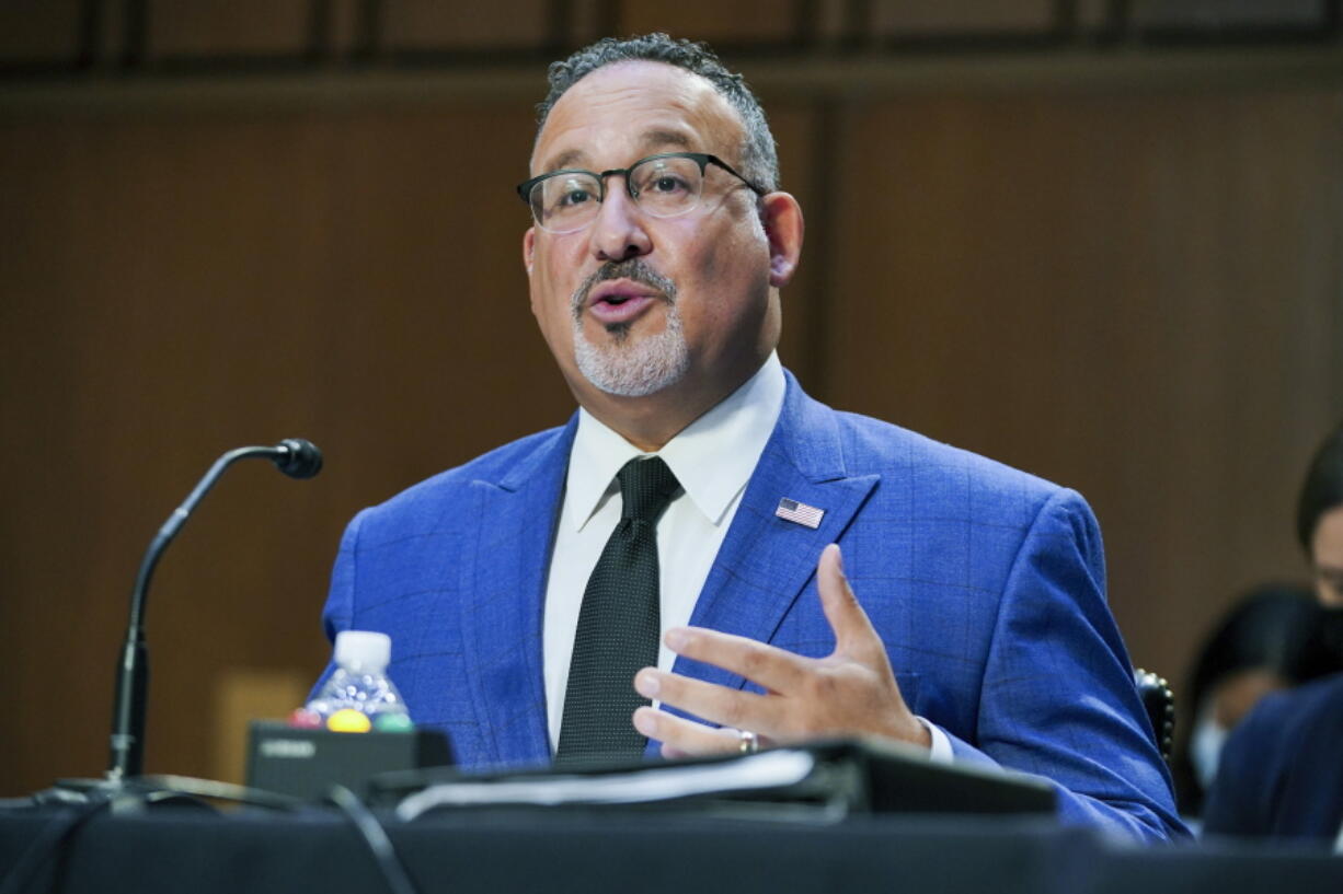 In this Sept. 30, 2021, file photo, Education Secretary Miguel Cardona testifies on Capitol Hill in Washington. The Biden administration is moving to relax the rules for a student loan forgiveness program that has been criticized for its notoriously complex requirements. The change could offer debt relief to thousands of teachers, social workers, military members and other public servants. The Education Department says it will temporarily drop some of the toughest requirements around the program, Public Service Loan Forgiveness, which was launched in 2007 to steer more college graduates into public service.