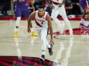 Portland Trail Blazers guard CJ McCollum gestures after making a 3-point basket against the Phoenix Suns during the second half of an NBA basketball game in Portland, Ore., Saturday, Oct. 23, 2021.