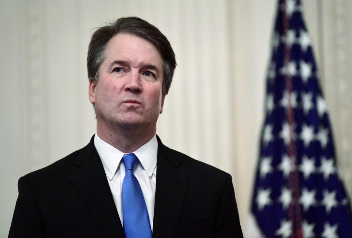 FILE - In this Oct. 8, 2018 file photo, Supreme Court Justice Brett Kavanaugh stands before a ceremonial swearing-in in the East Room of the White House in Washington. The Supreme Court says Justice Brett Kavanaugh has tested positive for COVID-19. The high court said in a press release Friday that Kavanaugh has no symptoms and has been fully vaccinated since January.