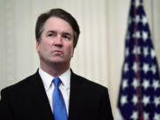 FILE - In this Oct. 8, 2018 file photo, Supreme Court Justice Brett Kavanaugh stands before a ceremonial swearing-in in the East Room of the White House in Washington. The Supreme Court says Justice Brett Kavanaugh has tested positive for COVID-19. The high court said in a press release Friday that Kavanaugh has no symptoms and has been fully vaccinated since January.