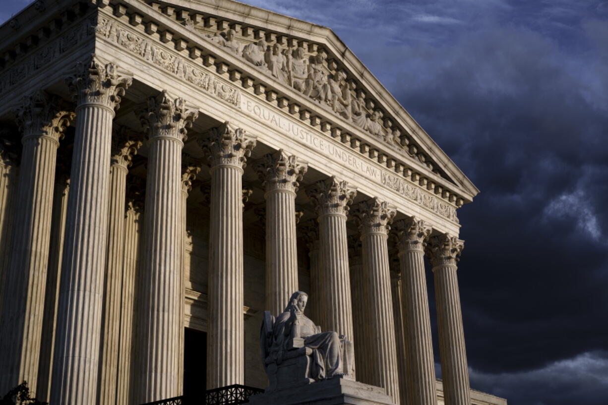 FILE - The Supreme Court is seen at dusk in Washington, Friday, Oct. 22, 2021. The Supreme Court has rejected an emergency appeal from health care workers in Maine to block a vaccine mandate that went into effect Friday, Oct. 29. (AP Photo/J.