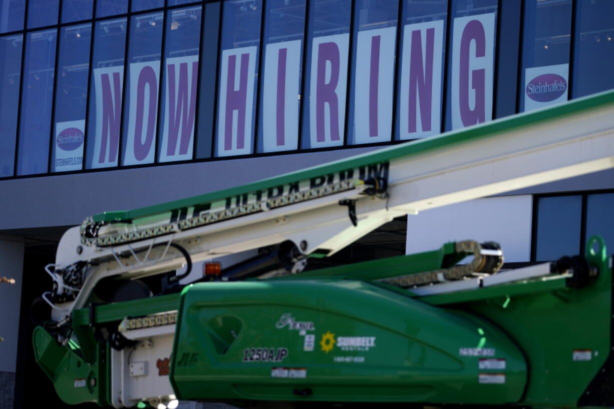 A hiring sign is displayed at a furniture store window on Friday, Sept. 17, 2021, in Downers Grove, Ill. Unemployment claims dropped 6,000 to 290,000 last week, the third straight drop, the Labor Department said Thursday, Oct. 21, 2021,. That's the fewest people to apply for benefits since March 14, 2020, when the pandemic intensified. (AP Photo/Nam Y.