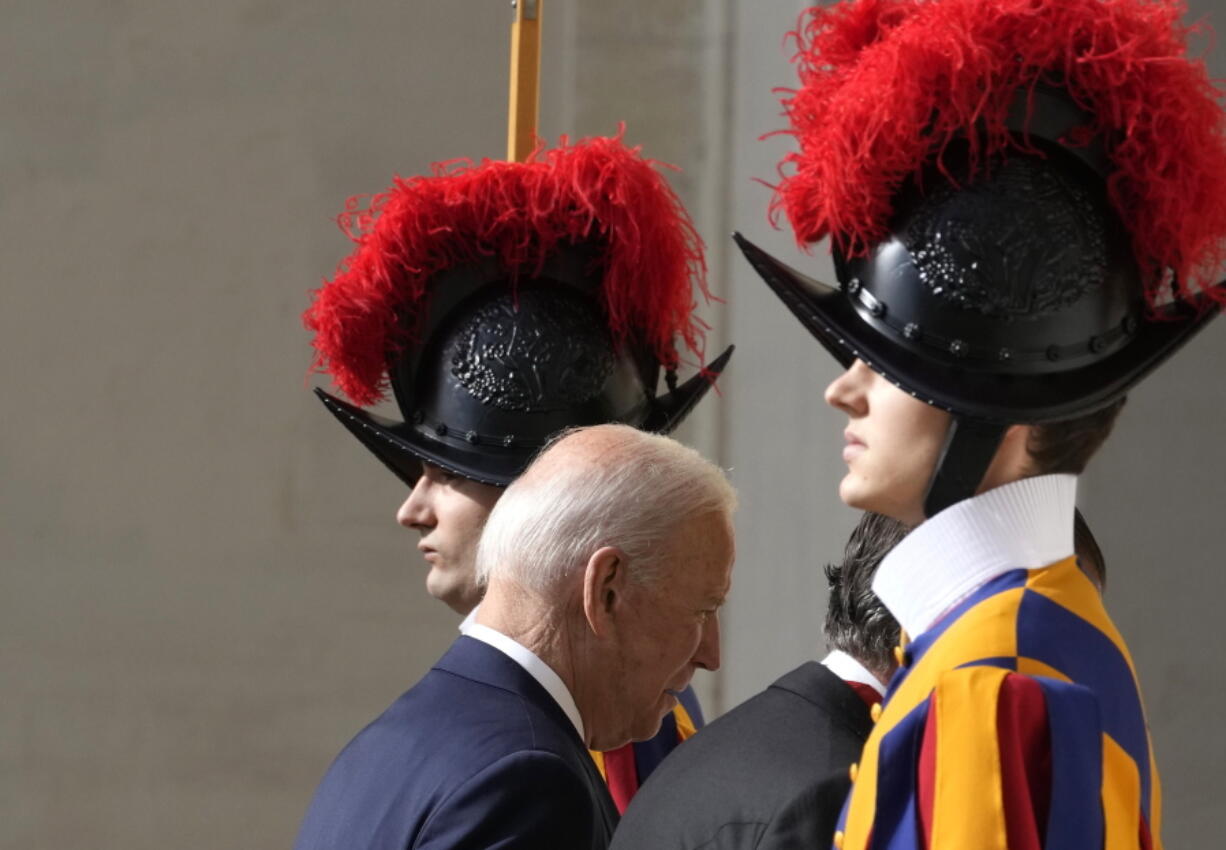 U.S. President Joe Biden walks past two Swiss Guards as he arrives for a meeting with Pope Francis at the Vatican, Friday, Oct. 29, 2021. A Group of 20 summit scheduled for this weekend in Rome is the first in-person gathering of leaders of the world's biggest economies since the COVID-19 pandemic started.