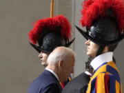 U.S. President Joe Biden walks past two Swiss Guards as he arrives for a meeting with Pope Francis at the Vatican, Friday, Oct. 29, 2021. A Group of 20 summit scheduled for this weekend in Rome is the first in-person gathering of leaders of the world's biggest economies since the COVID-19 pandemic started.