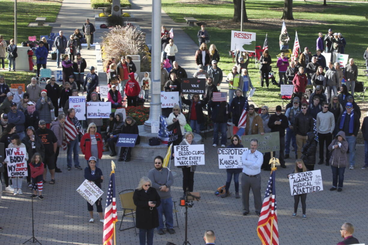 Opponents of COVID-19 vaccine mandates rally outside the Kansas Statehouse, Saturday, Oct. 30, 2021, in Topeka, Kan. The rally drew several hundred people as a legislative committee took testimony about mandates from President Joe Biden that could affect 100 million Americans.