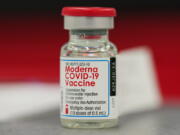 FILE - This Wednesday, Dec. 23, 2020 file photo shows a vial of the Moderna COVID-19 vaccine in the first round of staff vaccinations at a hospital in Denver. On Thursday, Oct. 14, 2021, U.S. health advisers said that some Americans who received Moderna's COVID-19 vaccine should get a half-dose booster to bolster protection against the virus.