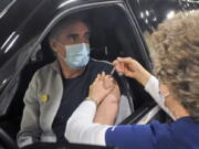 FILE - In this March 21, 2021, file photo, North Dakota Gov. Doug Burgum receives a COVID-19 vaccination from registered nurse Naomi Friesz during a drive-thru clinic in the Bismarck Event Center in Bismarck, N.D. The North Dakota Department of Health on Tuesday, Oct. 26. 2021, switched off comments on its social media accounts, saying it was doing so to combat the spread of misinformation.