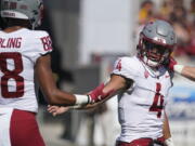 Washington State quarterback Jayden deLaura (4) gets congratulations from De'Zhaun Stribling (88) after scoring a touchdown against Arizona State during the first half of an NCAA college football game, Saturday, Oct 30, 2021, in Tempe, Ariz.