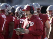 Washington State defensive coordinator and linebackers coach Jake Dickert, center, was named interim head coach on Monday.