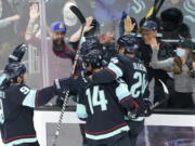 Seattle Kraken players celebrate after Haydn Fleury scored against the Minnesota Wild during the second period of an NHL hockey game, Thursday, Oct. 28, 2021, in Seattle. (AP Photo/Ted S.