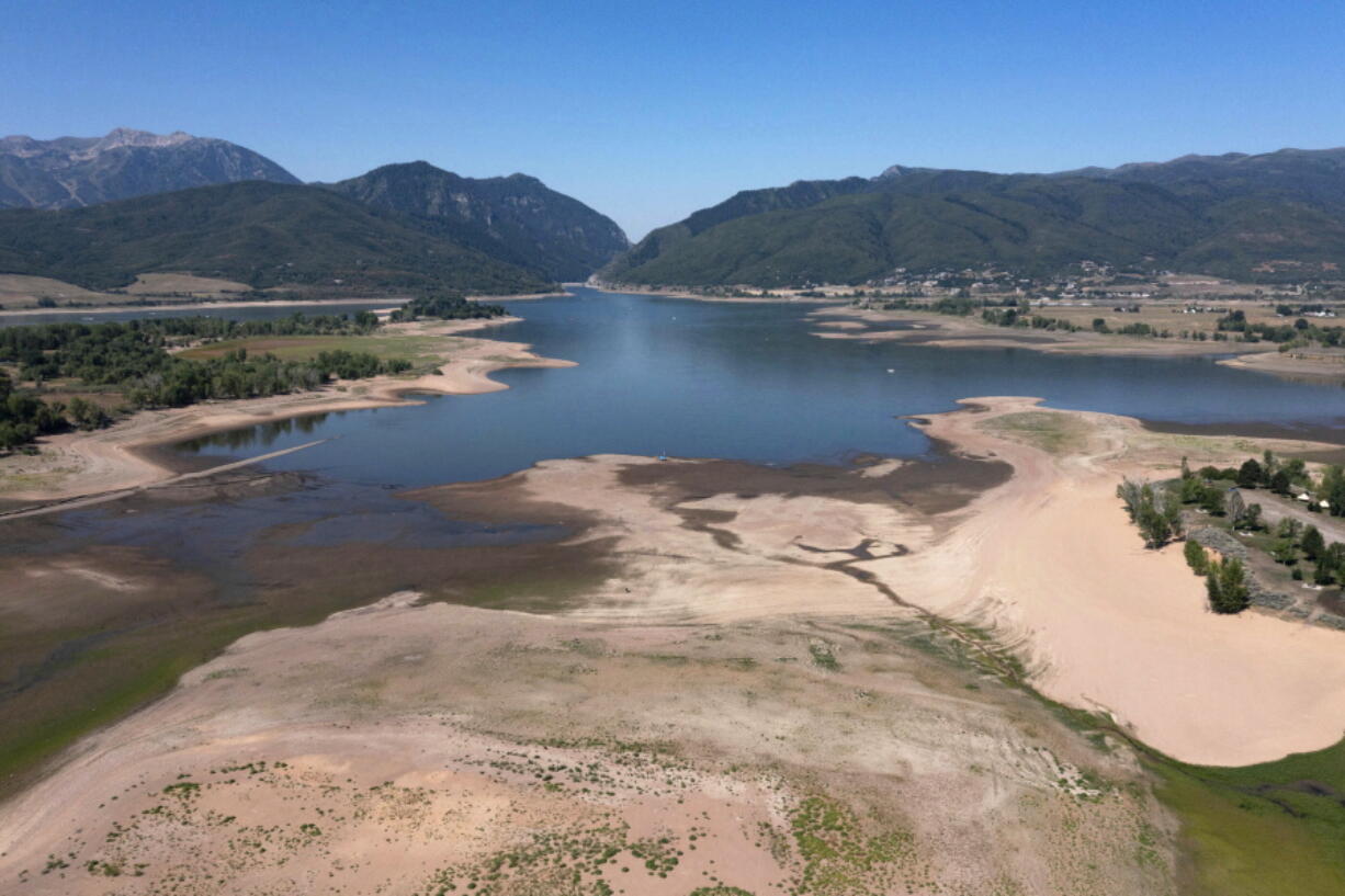 FILE - This Thursday, Aug. 12, 2021 file photo shows the Pineview Reservoir, a popular recreation spot in Ogden Valley, at a quarter full. Expect a drier, warmer winter down south and a wetter winter up north, the National Weather Service said Thursday, Oct. 21, 2021.