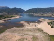 FILE - This Thursday, Aug. 12, 2021 file photo shows the Pineview Reservoir, a popular recreation spot in Ogden Valley, at a quarter full. Expect a drier, warmer winter down south and a wetter winter up north, the National Weather Service said Thursday, Oct. 21, 2021.