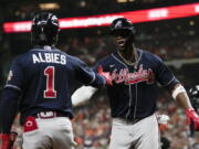 Atlanta Braves' Jorge Soler celebrates with Ozzie Albies after a home run during the first inning of Game 1 in baseball's World Series between the Houston Astros and the Atlanta Braves Tuesday, Oct. 26, 2021, in Houston.