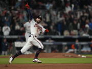 Atlanta Braves' Dansby Swanson celebrates his home run during the seventh inning in Game 4 of baseball's World Series between the Houston Astros and the Atlanta Braves Saturday, Oct. 30, 2021, in Atlanta. (AP Photo/David J.