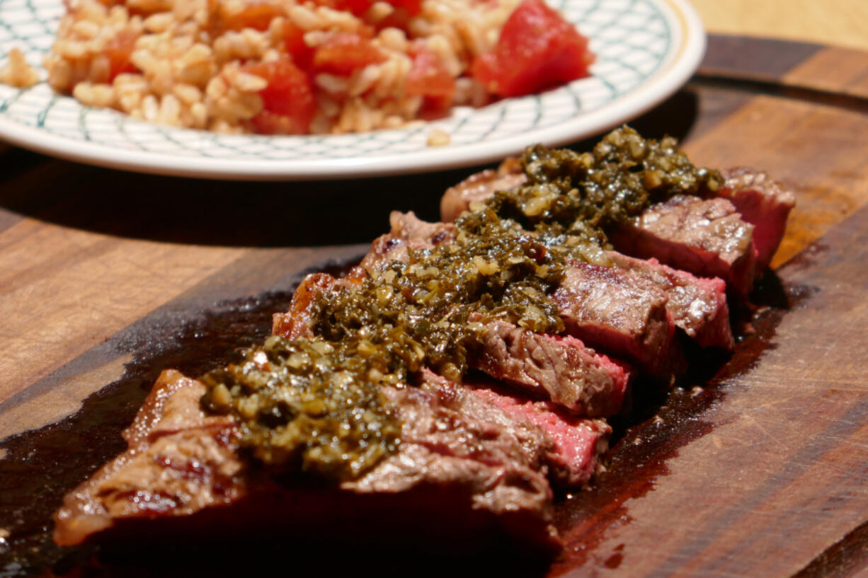 Churrasco Steak with Chimichurri Sauce and Rice and Tomatoes.