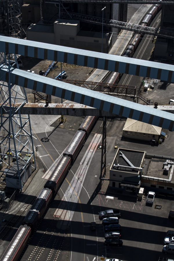 A train moves past United Grain at the Port of Vancouver.  Railroad companies have raised their rates twice in the past year, adding to the rising cost of business at United Grain.