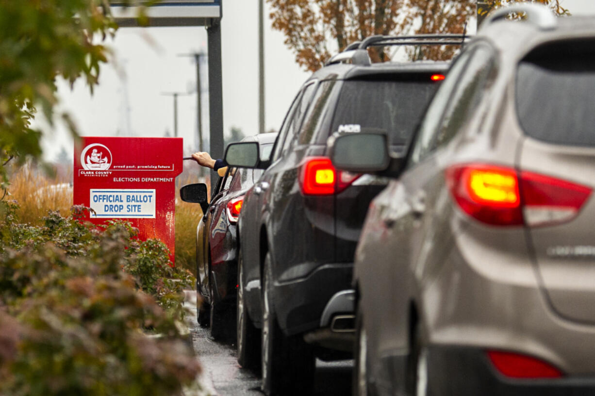 Drivers line up to drop off ballots at a Clark County ballot drop box in the Vancouver Mall parking lot in 2020. Voter turnout is shaping up to be low in this off-year election.