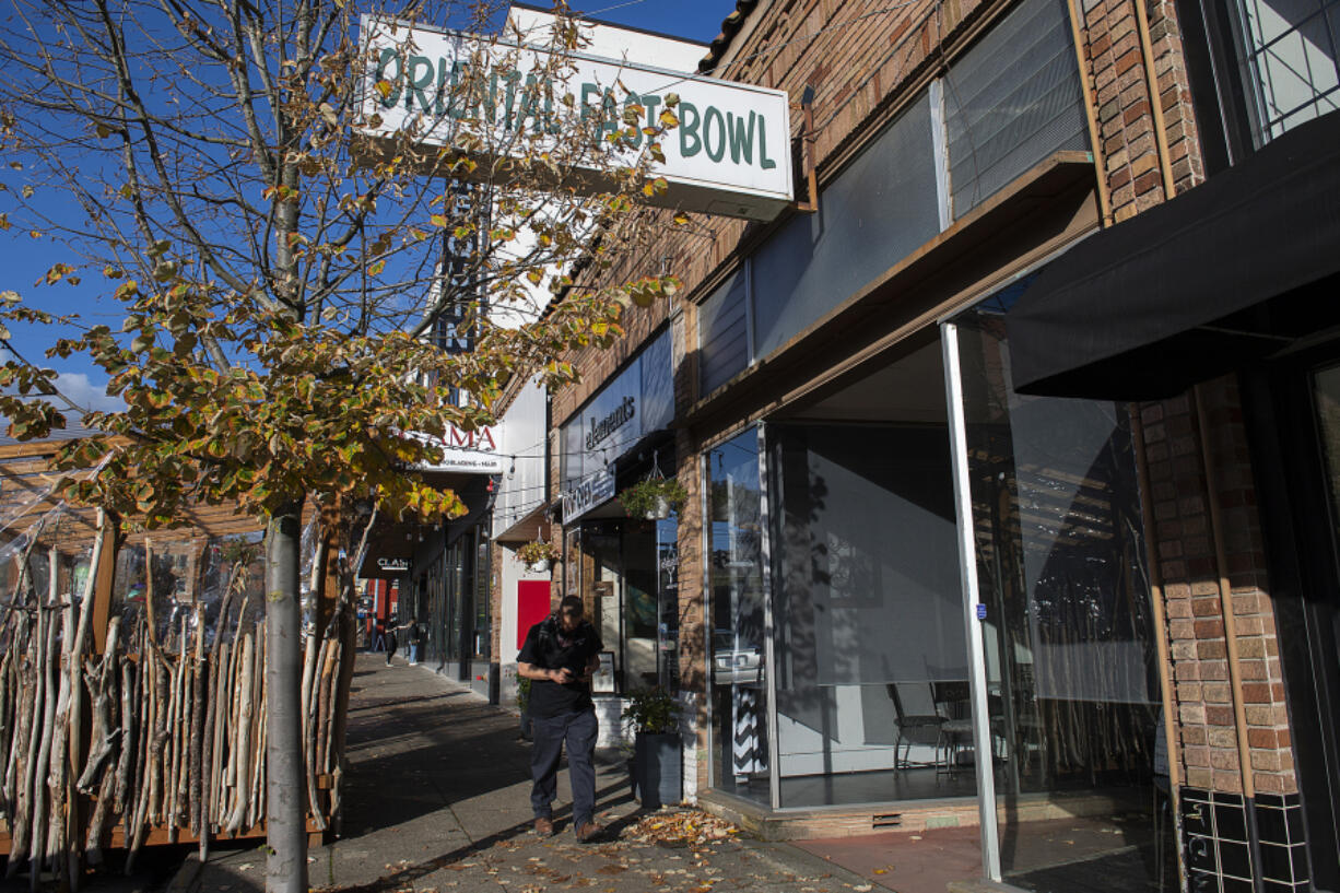 A pedestrian strolls past a future Bosnian restaurant called 7 Restaurant, which is in the former Oriental Fast Bowl at 950 Main St. in downtown Vancouver.