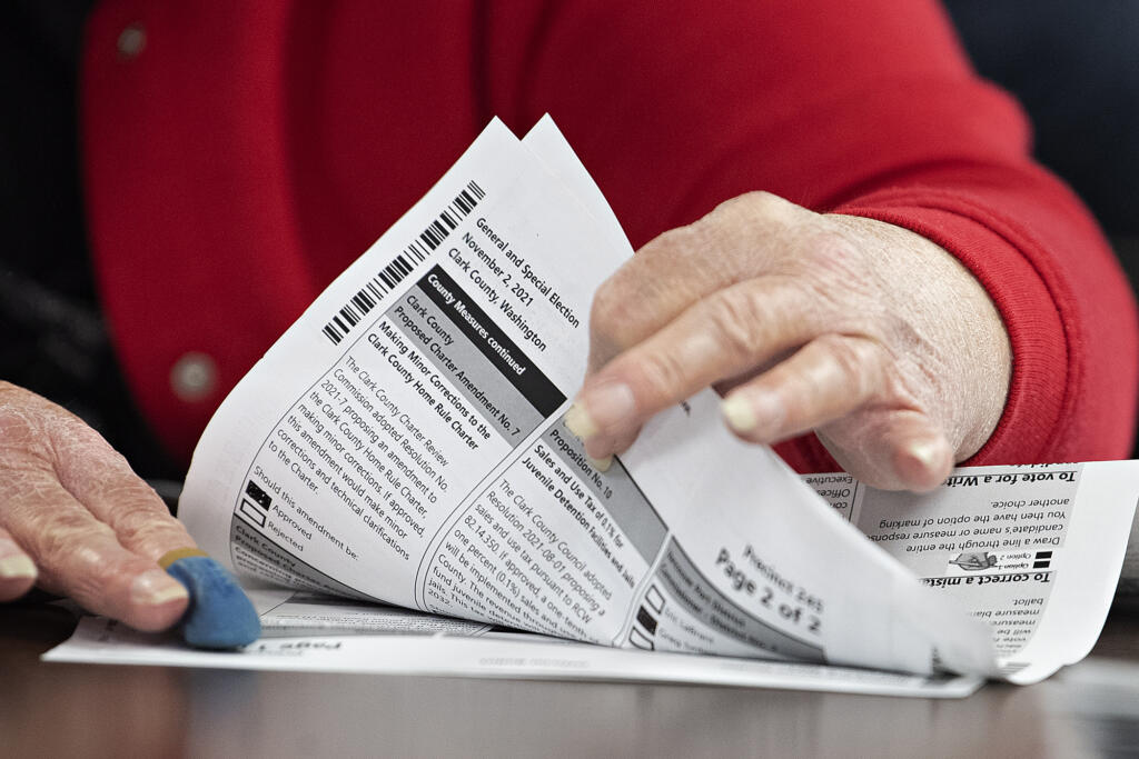 Ballot inspectors perform a manual count of 600 ballots to ensure election integrity at the Clark County Elections Office on Wednesday morning, Nov. 3, 2021.