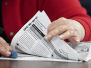 Ballot inspectors perform a manual count of 600 ballots to ensure election integrity at the Clark County Elections Office on Wednesday morning, Nov. 3, 2021.